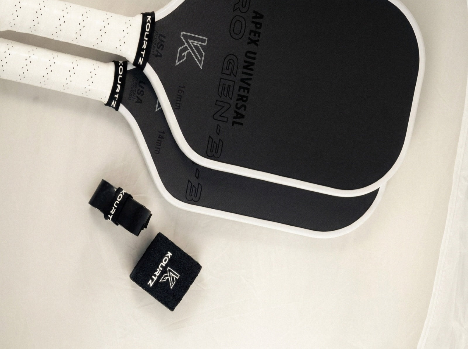 Apex Pro Gen-3 16 mm and 14 mm with overgrip and sweatband, flat lay